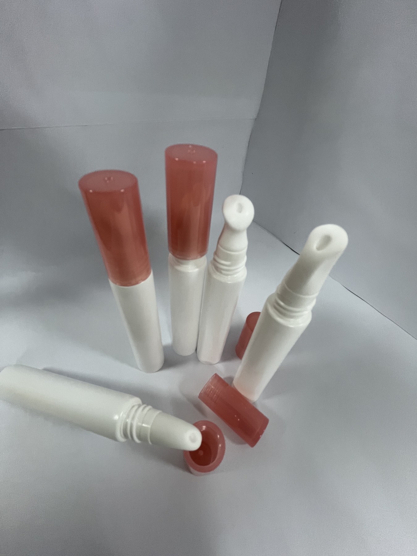 Cosmetic tube samples showing caps and applicator openings